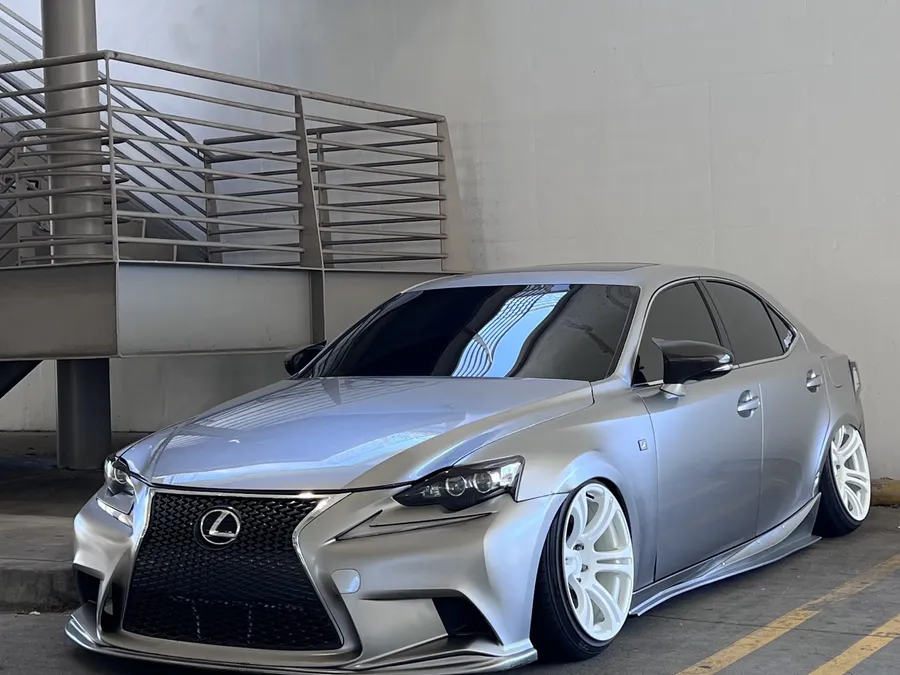 Silver Lexus IS with tinted windows in the bay